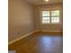 Neutral bedroom with hardwood floors, a window and white curtains at 2884 Mountbery Dr, Snellville, GA 30039