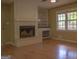 Living room showcasing a fireplace, built-in shelves, and a window at 2884 Mountbery Dr, Snellville, GA 30039