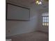 Living room with ceiling fan and large projector screen for entertainment at 2884 Mountbery Dr, Snellville, GA 30039