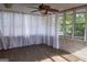 Sun room with white curtains and a ceiling fan to create a cool and relaxing space at 2884 Mountbery Dr, Snellville, GA 30039