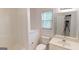 Bathroom featuring a toilet, sink, shower-tub combo, and neutral decor at 1461 Hada Ln, Lawrenceville, GA 30043