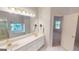 Bathroom with double sinks, a large mirror, and a separate bathtub with a shower behind glass at 1461 Hada Ln, Lawrenceville, GA 30043