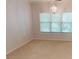 This bedroom features bright lighting, neutral tones, and a window that provides plenty of natural light at 1461 Hada Ln, Lawrenceville, GA 30043