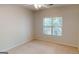 Empty bedroom with neutral walls and carpet, bright window offering ample natural light at 1461 Hada Ln, Lawrenceville, GA 30043