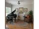Formal sitting room with piano, guitar, and leather armchair at 1461 Hada Ln, Lawrenceville, GA 30043