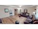 Spacious living room with hardwood floors and comfortable leather sofas, perfect for relaxing and entertaining at 1461 Hada Ln, Lawrenceville, GA 30043