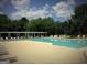 Large community pool with lounge chairs and a covered seating area at 1461 Hada Ln, Lawrenceville, GA 30043