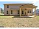 A view of the back of the home with a covered patio with an outdoor fan at 161 Jodi Pl, Locust Grove, GA 30248