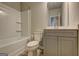 Bright bathroom features a shower and tub, with a gray vanity and a toilet at 161 Jodi Pl, Locust Grove, GA 30248