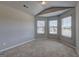 Neutral bedroom with carpet flooring and three windows overlooking the street at 161 Jodi Pl, Locust Grove, GA 30248