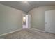 Neutral bedroom with carpet flooring, two doors and a partial view of the staircase at 161 Jodi Pl, Locust Grove, GA 30248