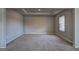 Bedroom features a coffered ceiling, neutral paint, carpeted floor, and one window at 161 Jodi Pl, Locust Grove, GA 30248