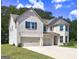 Charming two-story home showcases a three-car garage and an inviting driveway at 161 Jodi Pl, Locust Grove, GA 30248
