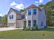 Two-story home featuring a three-car garage and a neatly manicured front yard at 161 Jodi Pl, Locust Grove, GA 30248