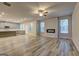 Spacious living room featuring wood-look flooring, large windows, and a cozy fireplace at 161 Jodi Pl, Locust Grove, GA 30248