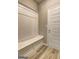 Mudroom featuring a custom bench with wainscoting and vinyl flooring at 161 Jodi Pl, Locust Grove, GA 30248