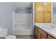 Bathroom features tub/shower combo with wood cabinets and blue walls at 125 Laney Ct, Mcdonough, GA 30252