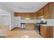 Traditional kitchen with wood cabinets, stainless steel appliances, and vinyl flooring at 125 Laney Ct, Mcdonough, GA 30252