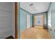 Room featuring blue walls, a closet with shelves, and a door to another room at 125 Laney Ct, Mcdonough, GA 30252