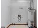 Utility room with water heater, vinyl tile flooring and wire shelving at 125 Laney Ct, Mcdonough, GA 30252