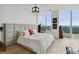 Bright bedroom with large windows, city views, wood floors and a padded headboard at 3630 Peachtree Rd # Ph3302, Atlanta, GA 30326