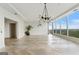 Bright, open living area with herringbone wood floors, modern chandeliers, and balcony access at 3630 Peachtree Rd # Ph3302, Atlanta, GA 30326