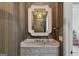 Stylish powder room features decorative wallpaper, marble countertop vanity, and modern mirror with lighting at 3630 Peachtree Rd # Ph3302, Atlanta, GA 30326