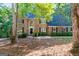 Traditional brick home with a manicured lawn and mature trees in a beautiful wooded neighborhood at 270 Emerald Lake Dr, Fayetteville, GA 30215