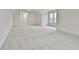 Large bonus room featuring wall-to-wall carpet and multiple windows at 150 Dockside Dr # 382, Fayetteville, GA 30215