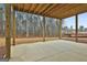 Covered patio with concrete flooring and wooded backyard views at 150 Dockside Dr # 382, Fayetteville, GA 30215