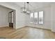 Formal dining room with hardwood floors and chandelier, open to living room at 150 Dockside Dr # 382, Fayetteville, GA 30215