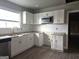 Bright kitchen featuring white cabinetry, stainless steel appliances, and granite countertops at 674 Jett Nw St, Atlanta, GA 30318