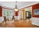 Spacious dining room with hardwood floors, large windows, and a chandelier at 625 Jefferson Pl, Cumming, GA 30040