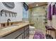 Bathroom featuring a shower with glass doors, elegant fixtures, and neutral tile at 470 Dix Lee On Dr, Fayetteville, GA 30214