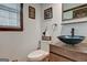 A modern half bathroom features a unique bowl sink and fixtures along with a window at 470 Dix Lee On Dr, Fayetteville, GA 30214