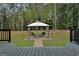 Backyard gazebo featuring paved walkway and two chairs, ideal for outdoor relaxation and entertaining at 470 Dix Lee On Dr, Fayetteville, GA 30214