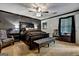 Elegant main bedroom with a dark wood bed, a ceiling fan, and soft lighting at 470 Dix Lee On Dr, Fayetteville, GA 30214