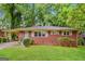 Ranch style brick house with a well manicured lawn at 2712 Cherry Laurel Sw Ln, Atlanta, GA 30311