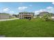 Expansive backyard with lush green lawn and treed border surrounding a brick home at 3140 Jackson Creek Dr, Stockbridge, GA 30281