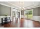 Formal dining area with hardwood floors, decorative ceiling, chandelier, and classic wainscoting at 3140 Jackson Creek Dr, Stockbridge, GA 30281