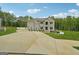 Expansive driveway leading to a distinguished brick home with meticulously maintained landscaping at 3140 Jackson Creek Dr, Stockbridge, GA 30281
