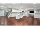 Open kitchen with white cabinets, center island, hardwood floors, and stainless appliances at 3140 Jackson Creek Dr, Stockbridge, GA 30281