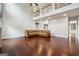 Spacious living room with a high ceiling, hardwood floors, and a comfortable leather couch at 3140 Jackson Creek Dr, Stockbridge, GA 30281