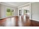 Bright living room featuring rich hardwood floors, decorative molding, and large windows at 3140 Jackson Creek Dr, Stockbridge, GA 30281