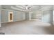 Spacious main bedroom with large windows, neutral color palette and plush carpet at 3140 Jackson Creek Dr, Stockbridge, GA 30281