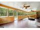 Bright sun room featuring wood paneling, multiple windows, and dual ceiling fans at 3140 Jackson Creek Dr, Stockbridge, GA 30281