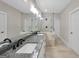 Modern bathroom with dual sinks, granite counters, and a glass-enclosed shower at 585 Highway 155 North N, Mcdonough, GA 30252