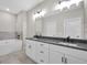 Bathroom with double vanity sinks and stylish lighting fixtures at 585 Highway 155 North N, Mcdonough, GA 30252