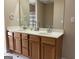 Double vanity bathroom with wood cabinets and a large mirror at 1876 Barrington Ct, Marietta, GA 30066