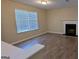 Bright living room with wood floors, a large window, and a cozy fireplace at 5300 Forest Downs Ln, Atlanta, GA 30349